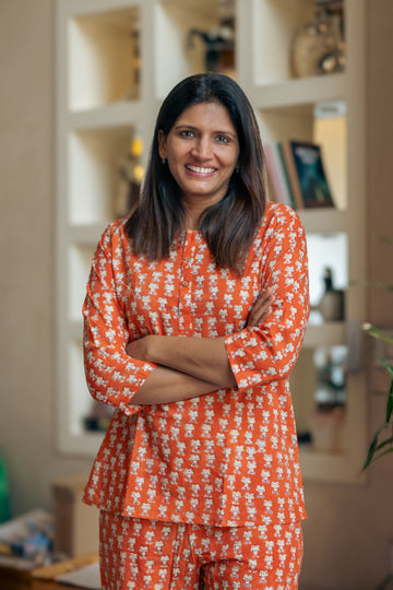 woman wearing orange frog pajama sets