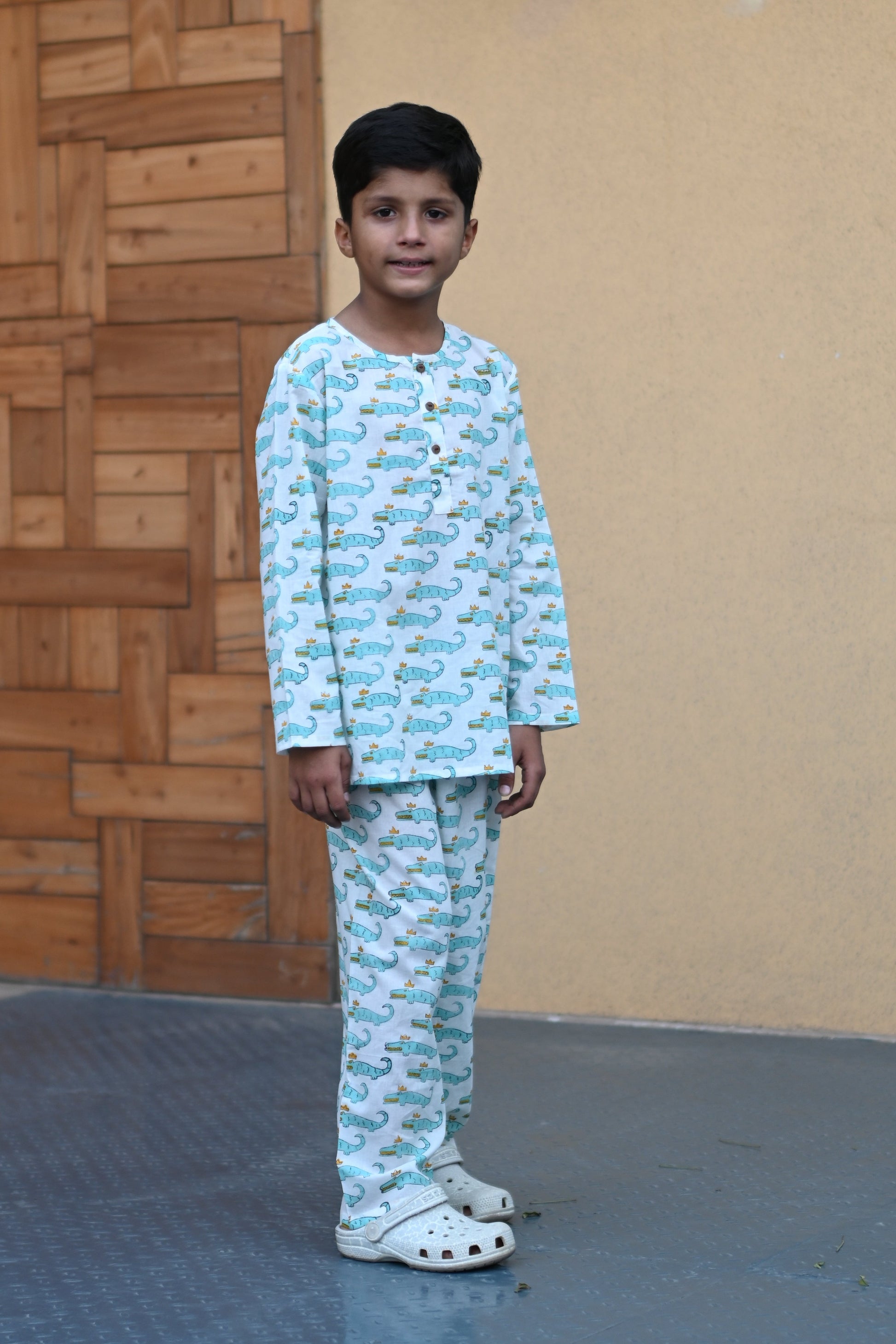 child wearing blue crocodile print nightsuit