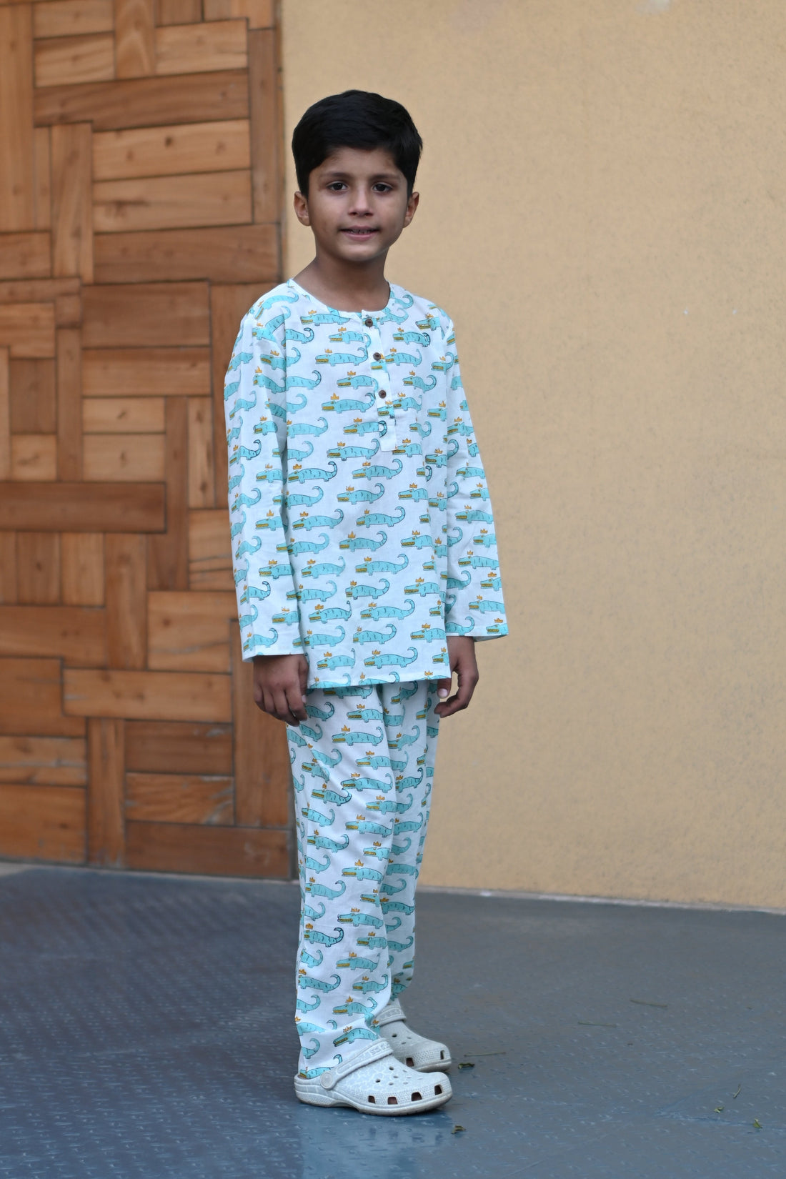 child wearing blue crocodile print nightsuit