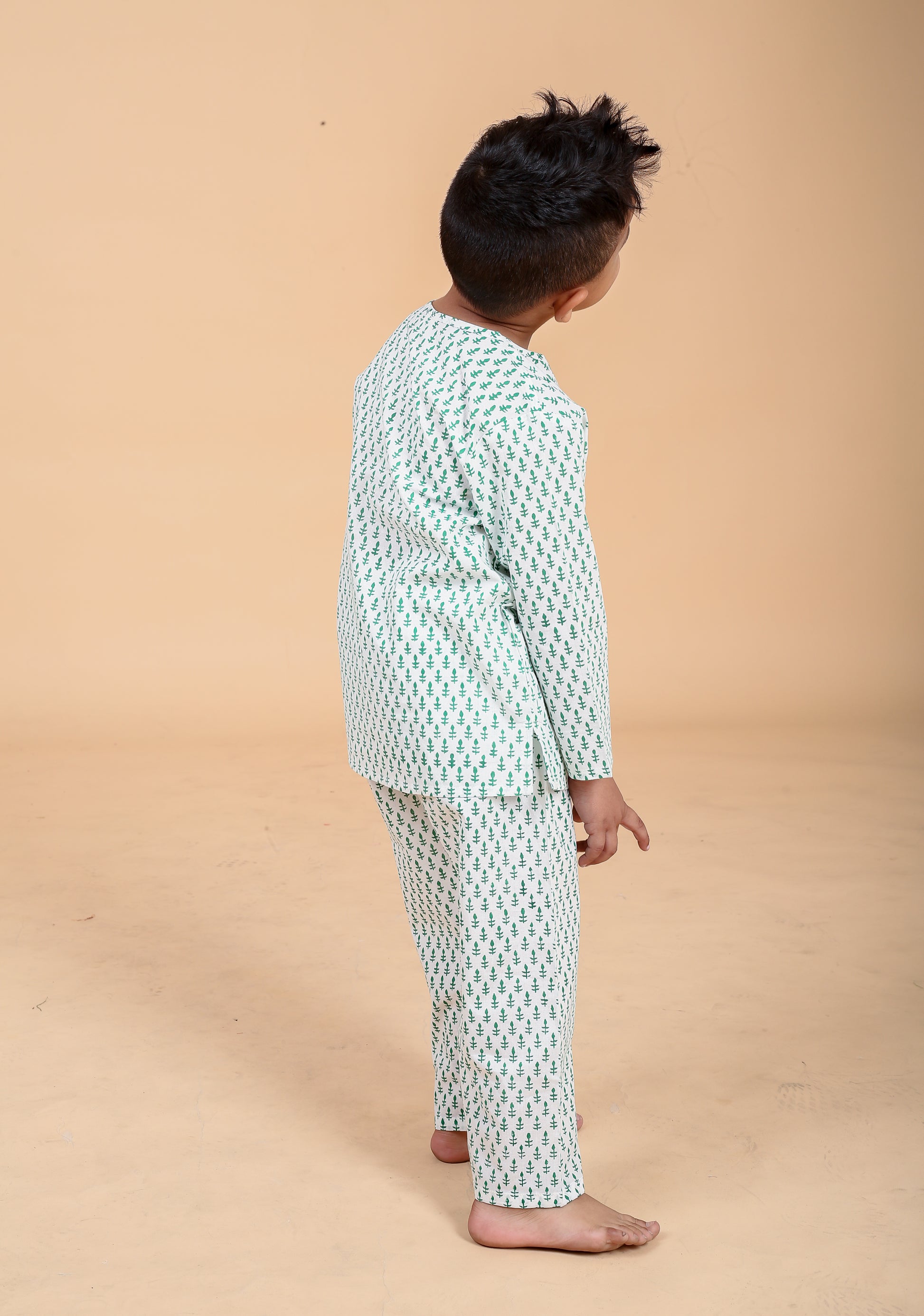 Boy wearing green booti hand block printed cotton pajama set- back view