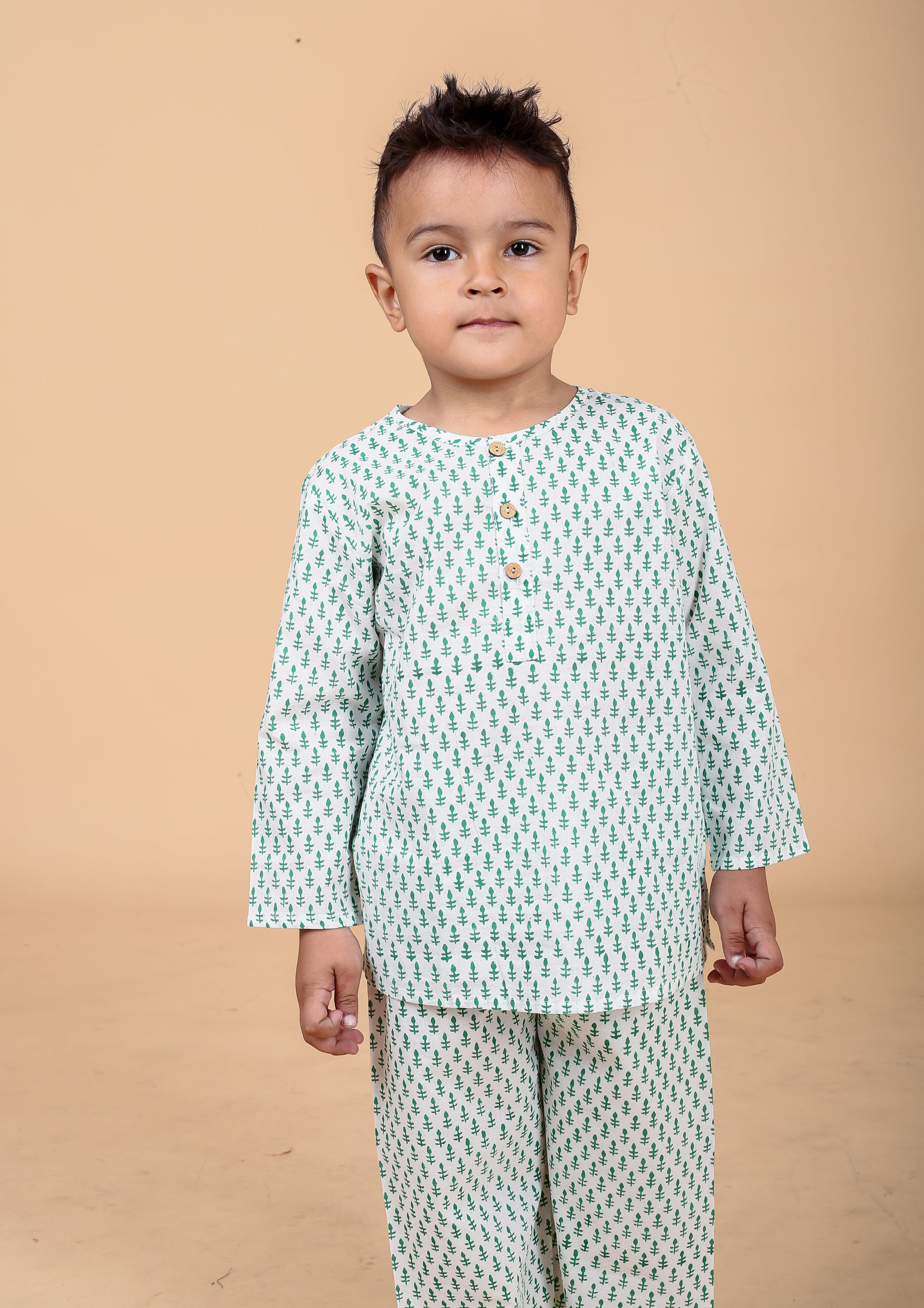 Boy wearing green booti hand block printed cotton pajama set