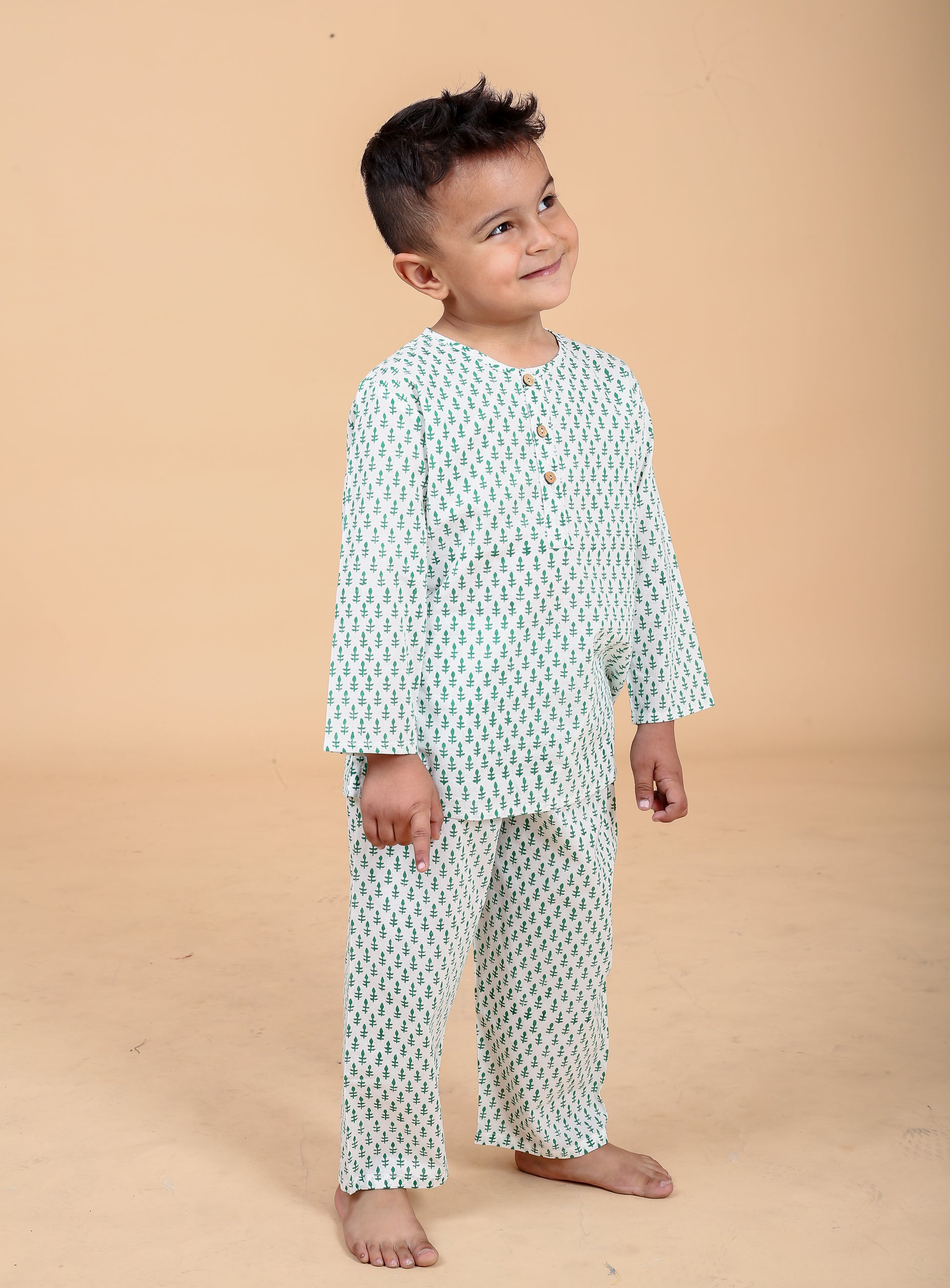 Boy wearing green booti hand block printed cotton pajama set - side view