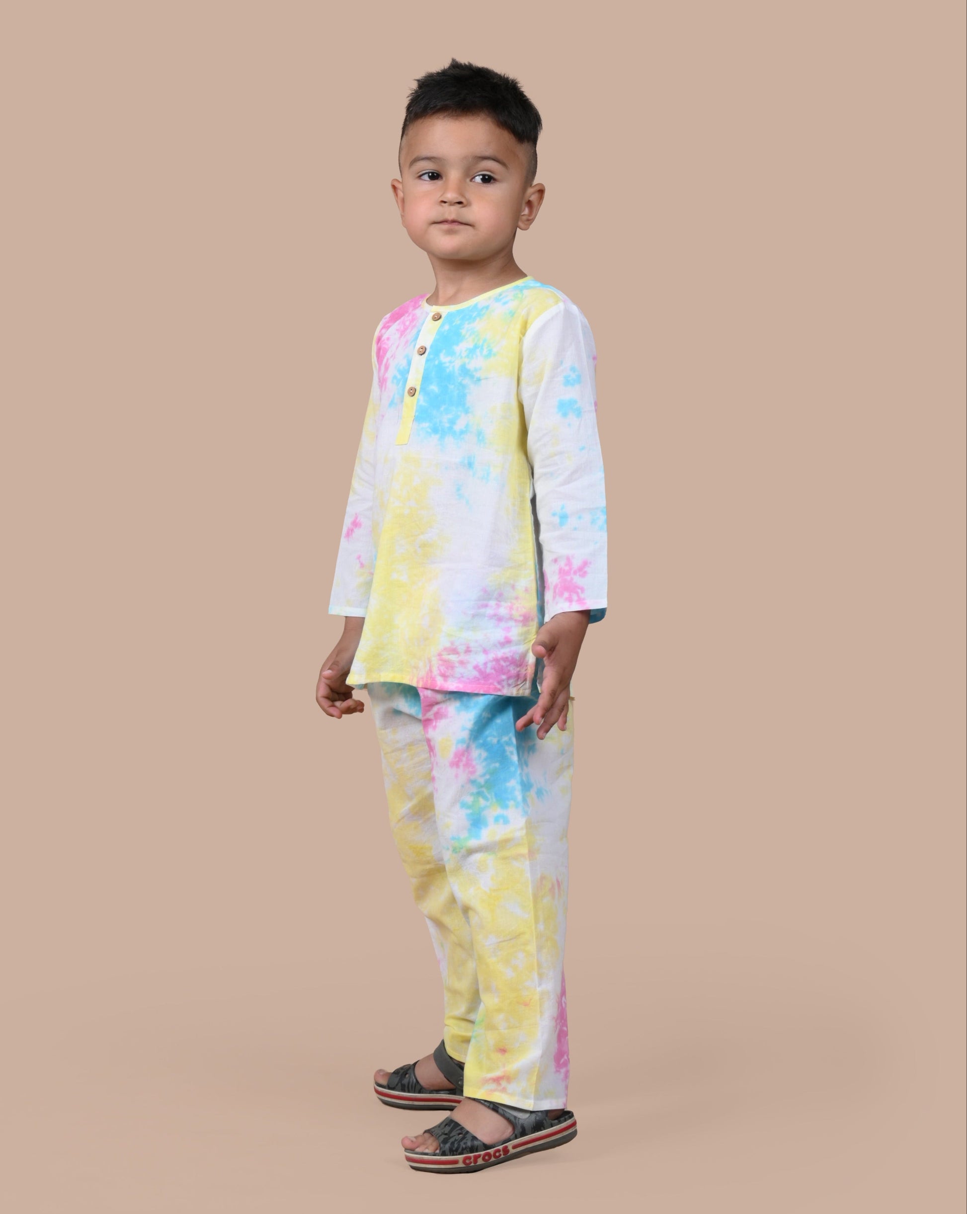 Boy wearing multi tie and dye pajama set, standing pose