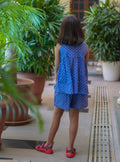 Girl in pure cotton purple dot print shorts set, side view