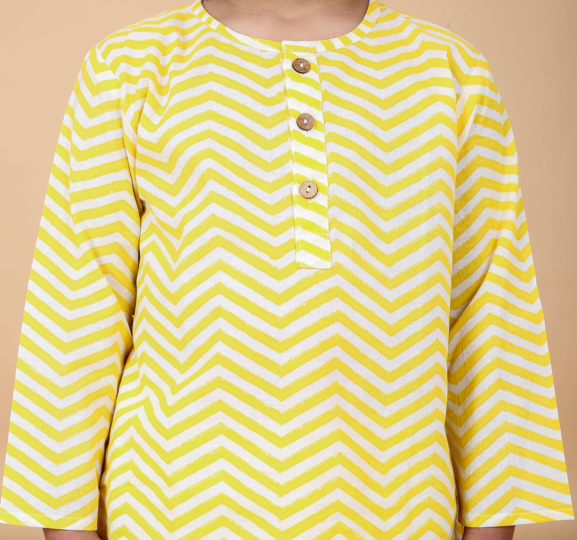 Close-up of yellow zig zag hand block print on cotton pajama top