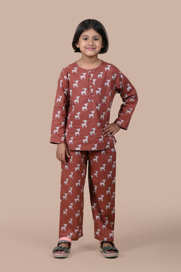Child wearing a brown pajama set with animal pattern on a beige background