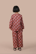 girl wearing a brown deer pajama set
