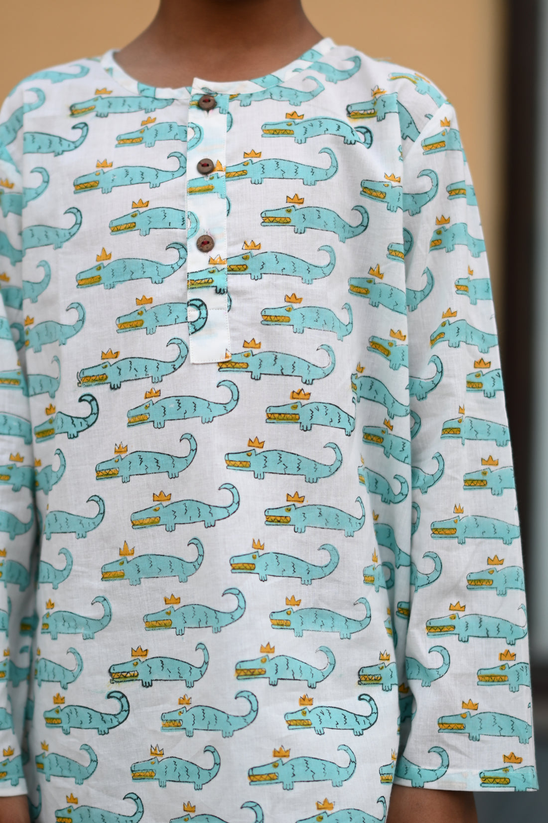child wearing blue crocodile print nightsuit