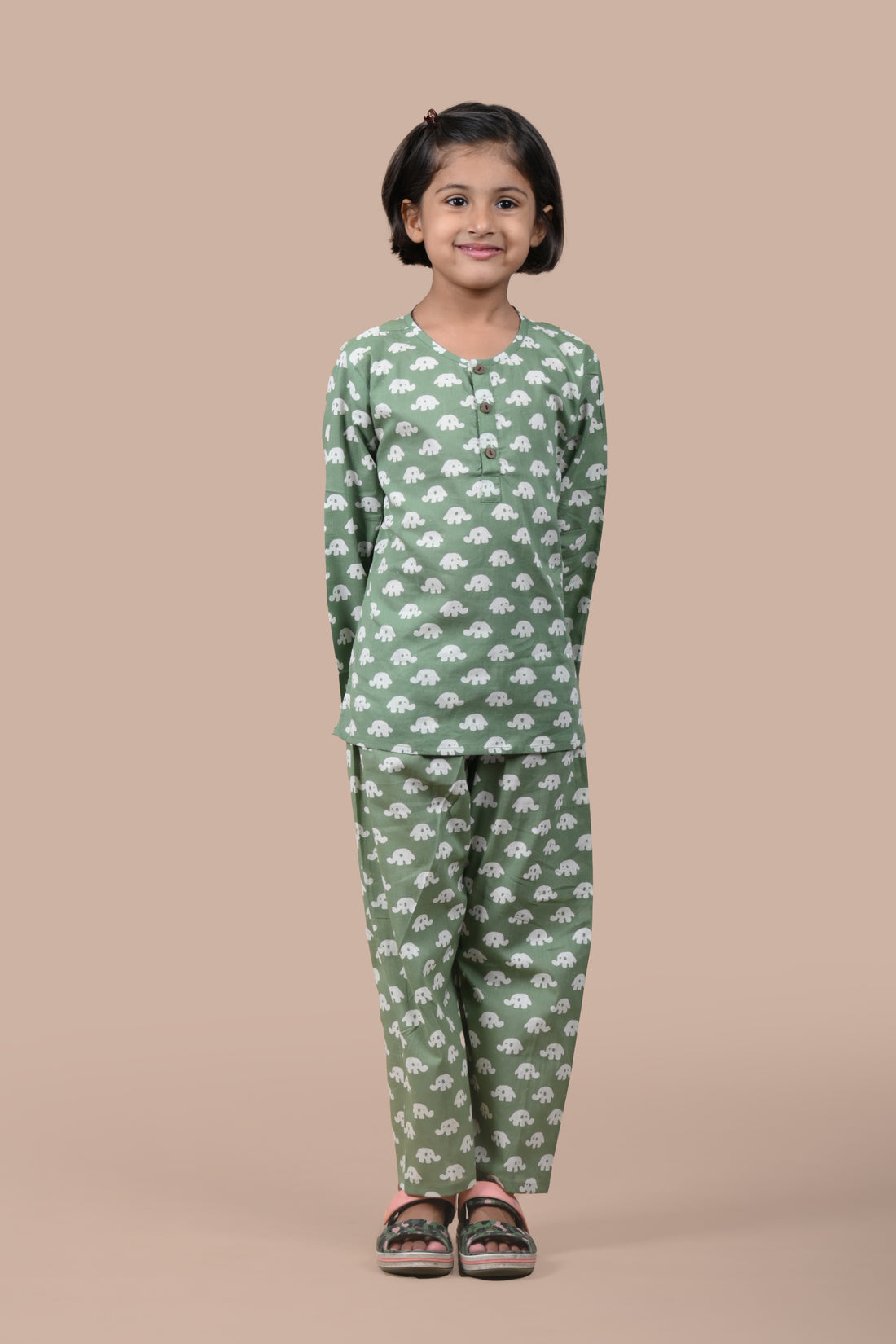 girl wearing dark green elephant printed cotton pajama set