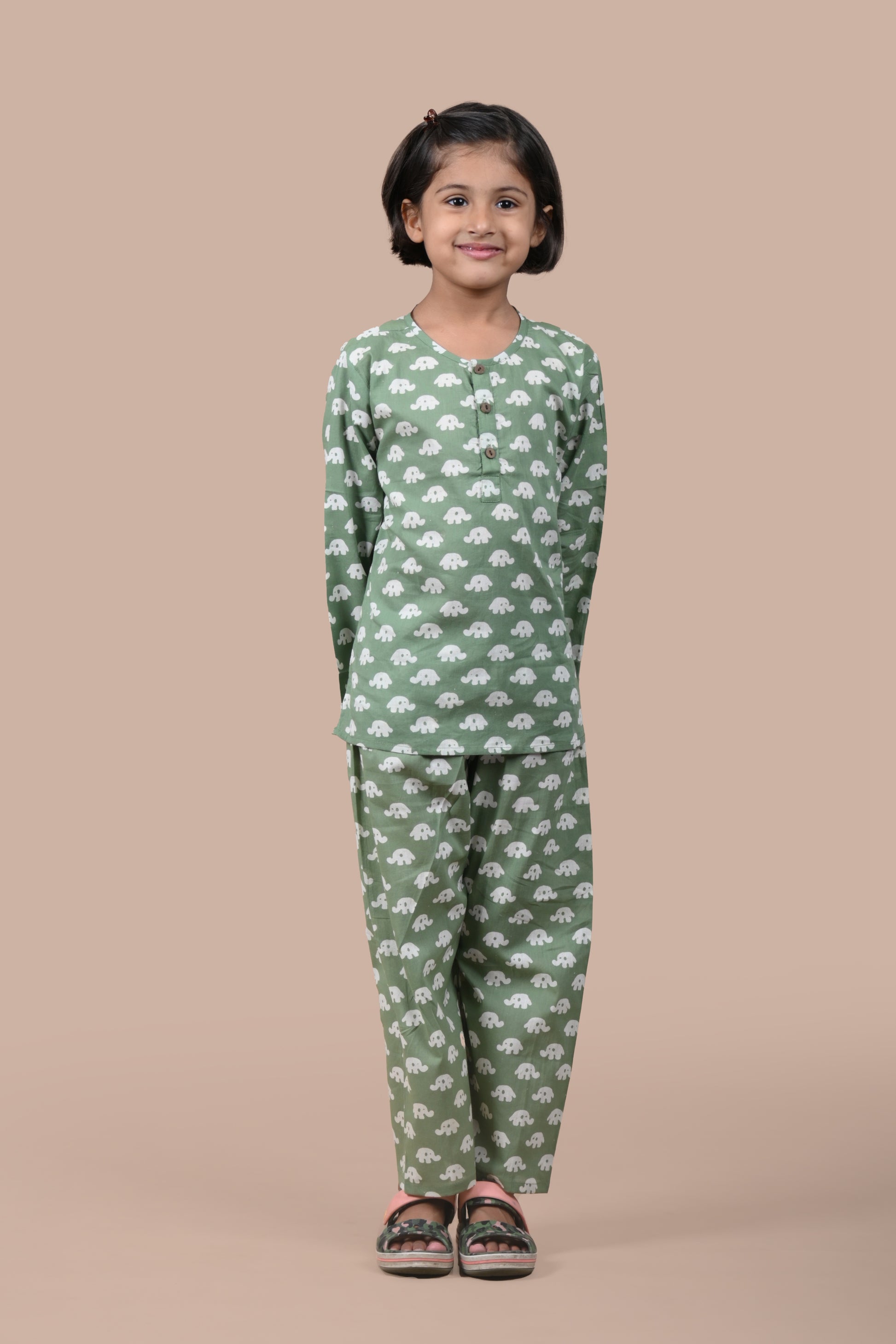 girl wearing dark green elephant printed cotton pajama set