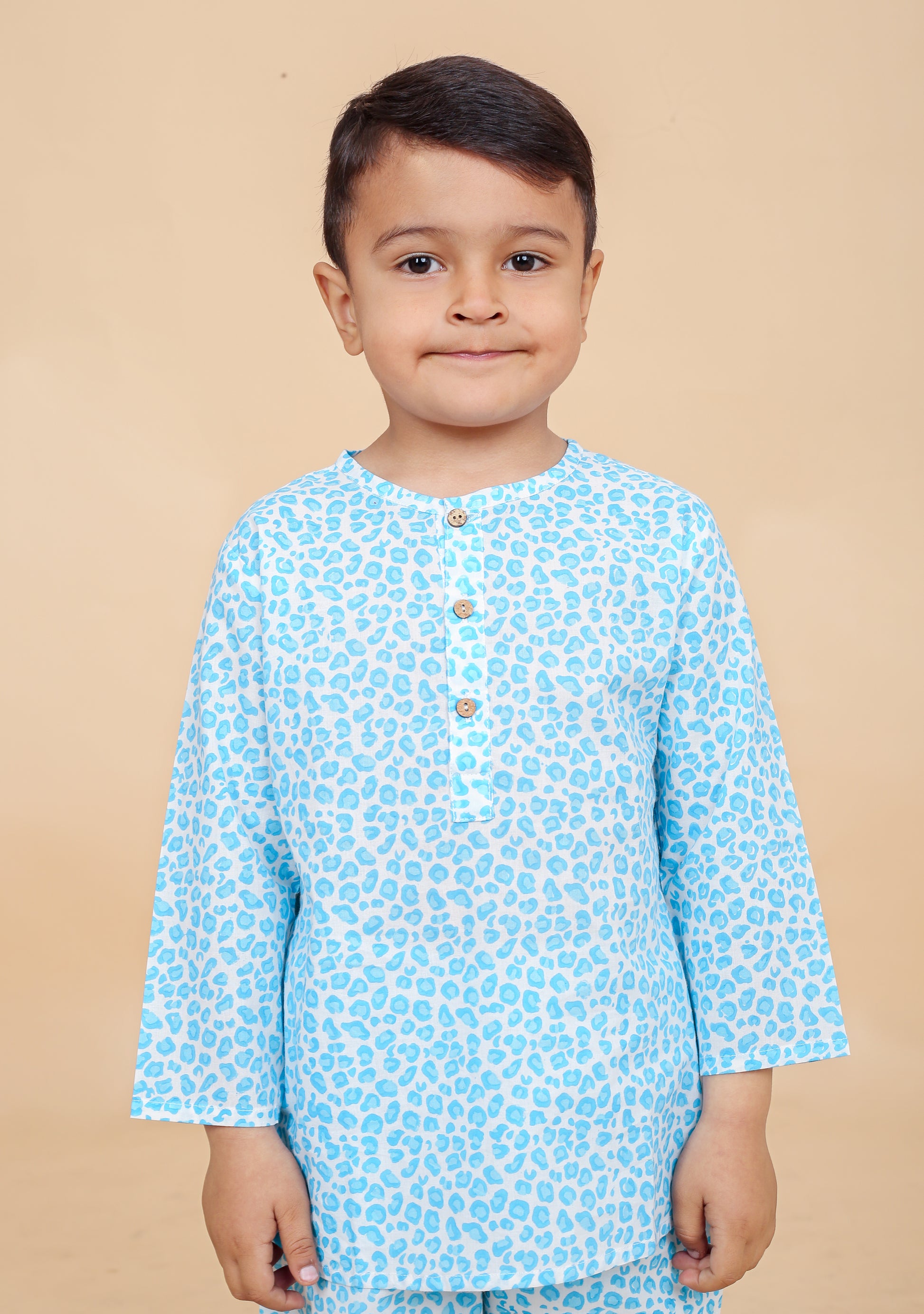 Close-up of boy in turquoise leopard print cotton pajama top