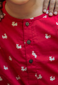 Red whlae nightsuit with black buttons worn by a person