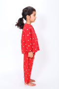 Girl wearing hand block printed red whale cotton night suit